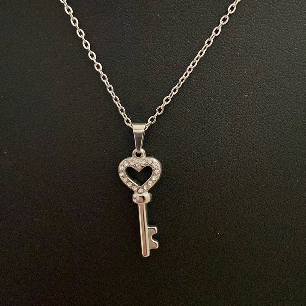 Stainless steel heart key charm on necklace.